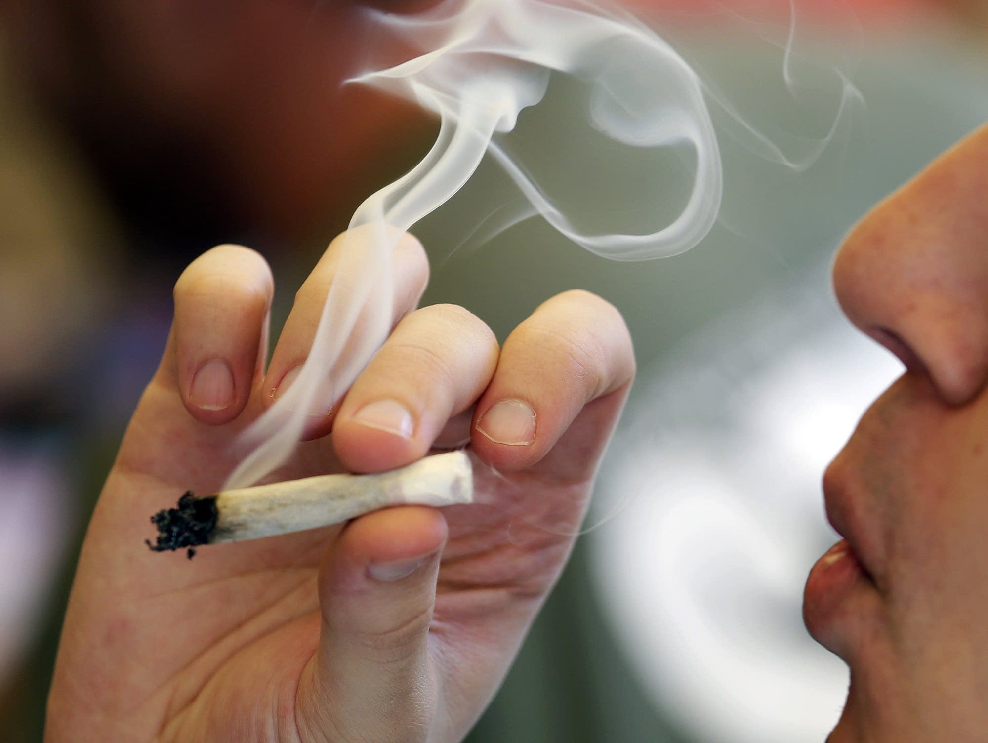 A man smokes a marijuana joint at a party celebrating weed in Seattle.