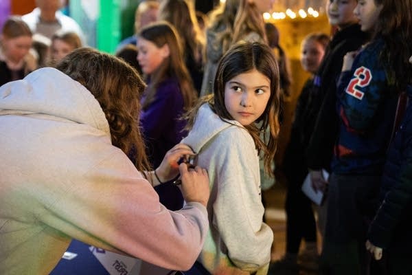 A girl gets her sweatshirt signed