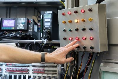 A hand being pointed at a panel
