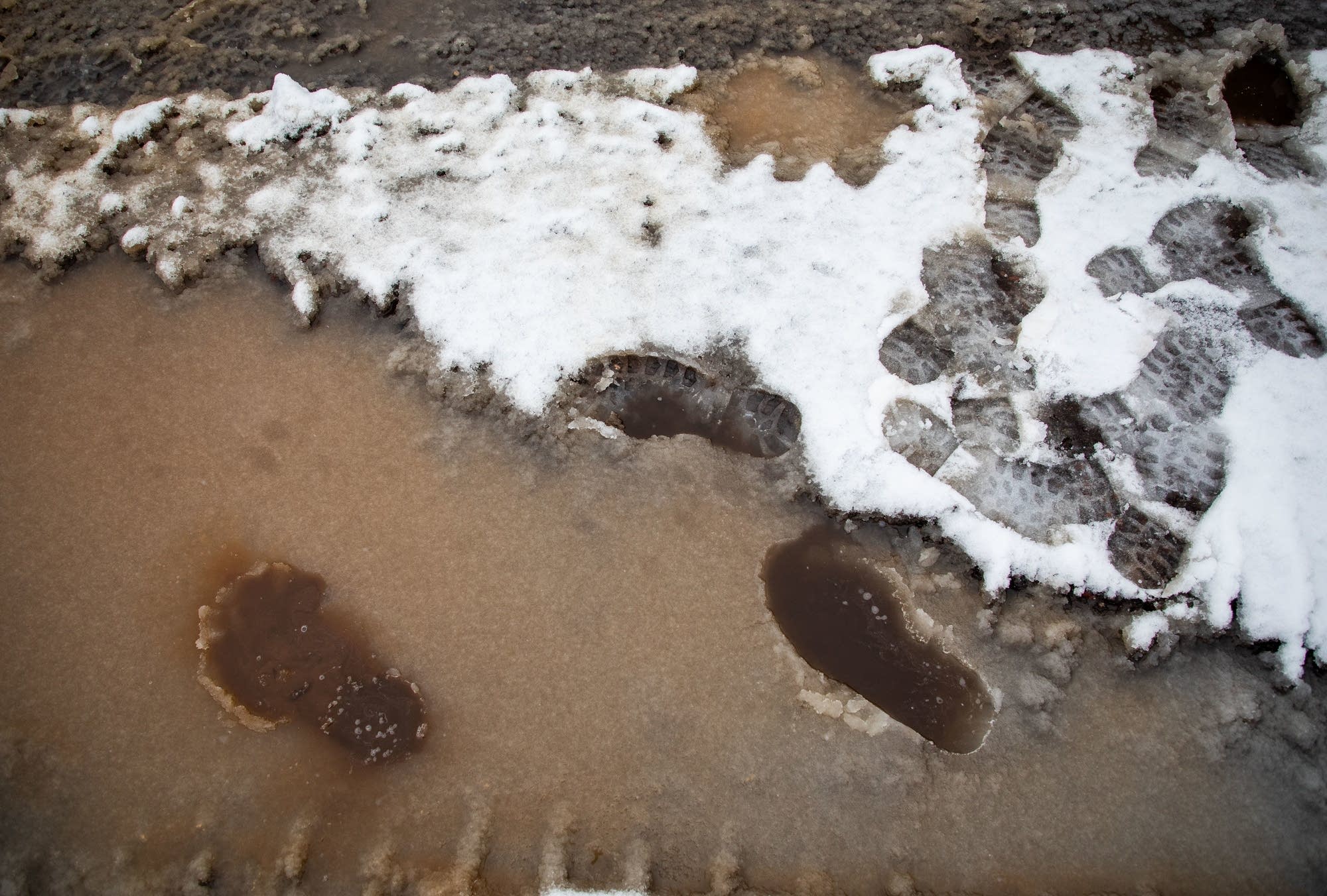 Footprints are left behind in slush at the College of St. Scholastica.