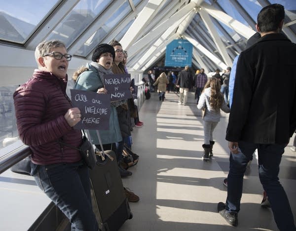 Protesters chant in the skyway over the baggage drop off zone.
