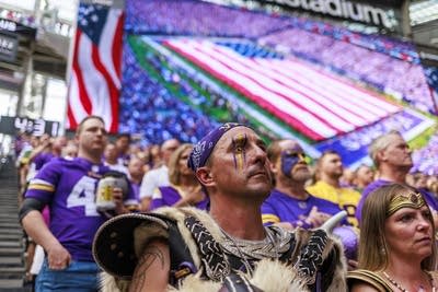 Fans stand during the national anthem