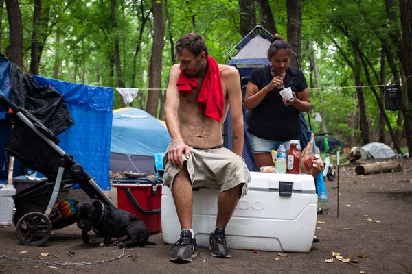 Two people relax at a campsite