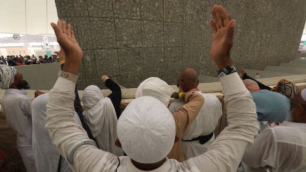 A man prays as Muslim pilgrims partake in the symbolic stoning of the devil at the Jamarat Bridge in Mina, near Mecca, which marks the final major rite of the Hajj on August 22, 2018.
