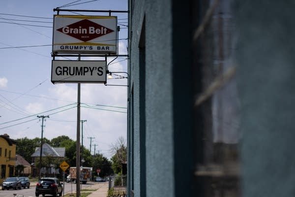 A sign hangs on the side of a building