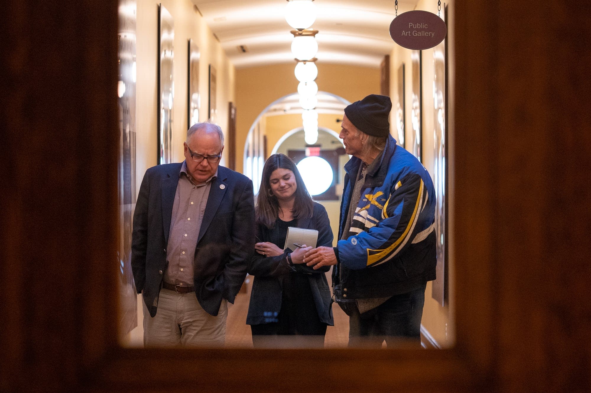 Governor-elect Tim Walz and former Gov. Jesse Ventura leave a meeting.