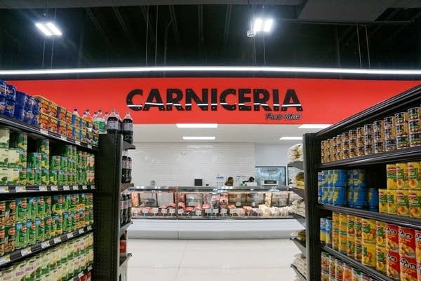 A red sign reading "Carniceria," seen through a market aisle.
