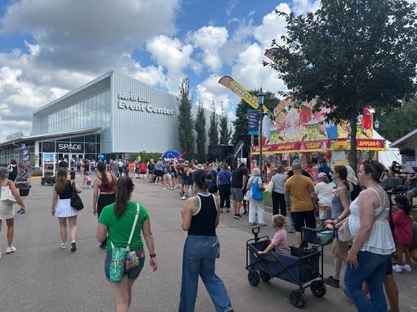 A crowd at the Minnesota State Fair walk outside the North End Event Center building.
