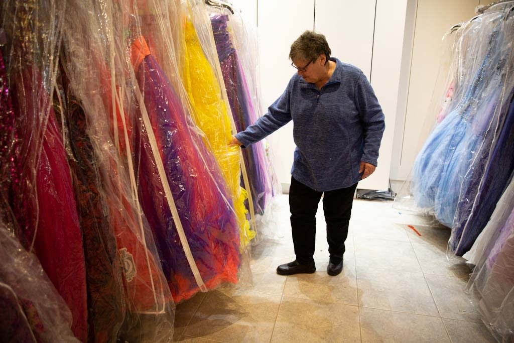Pam Philipp looks through prom dresses.