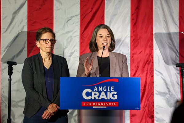 Angie Craig delivers a concession speech onstage next to her spouse.