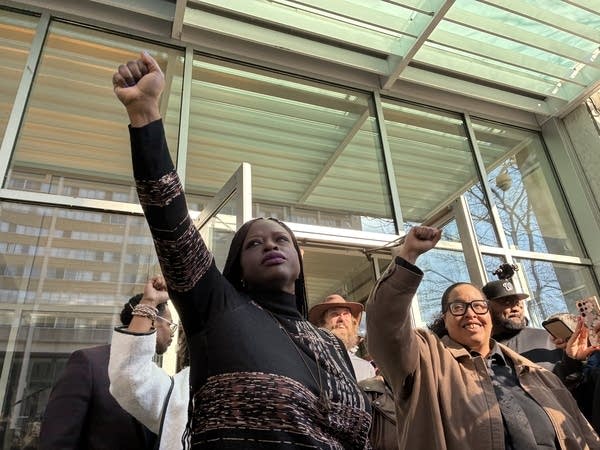 Civil rights attorney Nekima Levy Armstrong raises fist