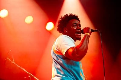 gr3g and his band performing on stage