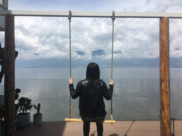 Marketplace's China correspondent, Jennifer Pak, enjoys a lake view in Shuanglang village, Yunnan province, after a grueling, 12-hour trip from Shanghai. (Jennifer Pak/Marketplace)