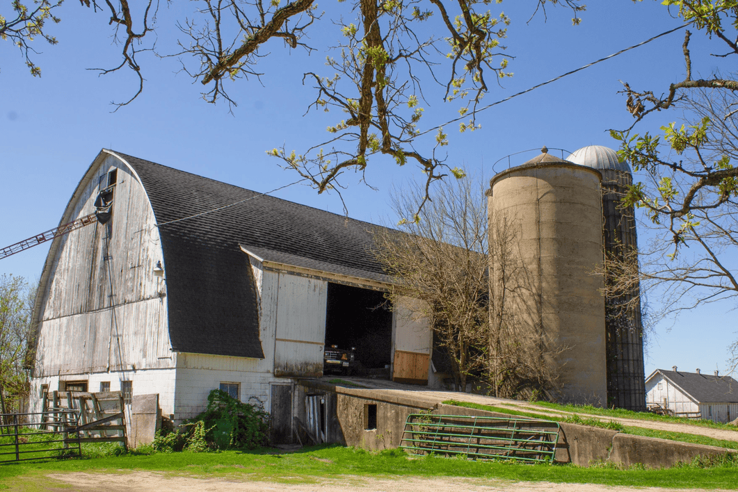 A silo near a barn