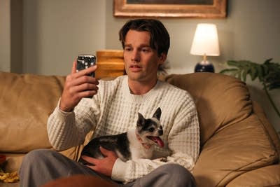 An actor looks at a smartphone during a sketch