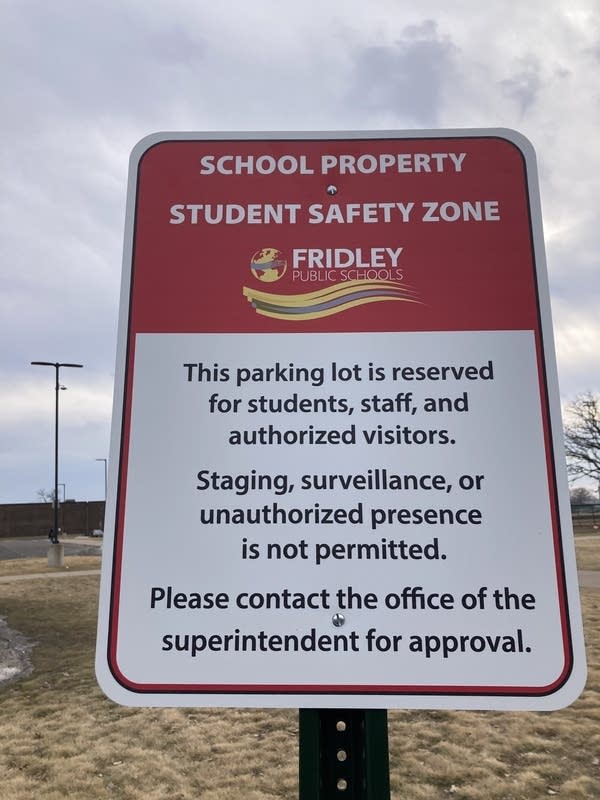 A sign in a parking lot