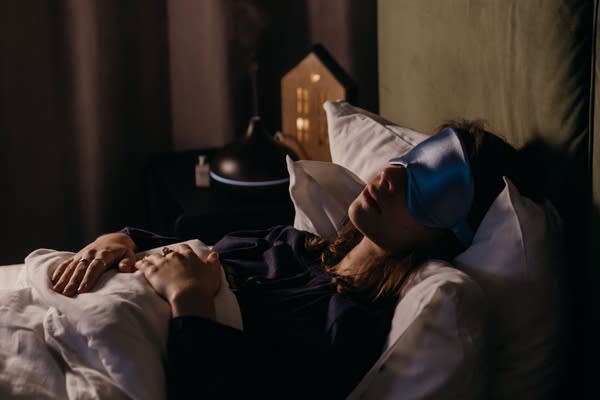 woman sleeping in blue eye mask