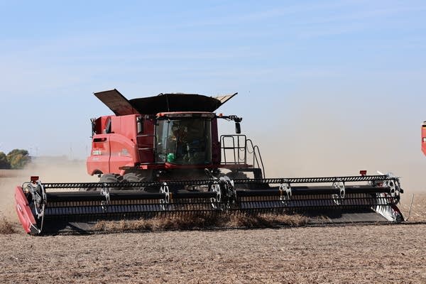A combine combs over a field.