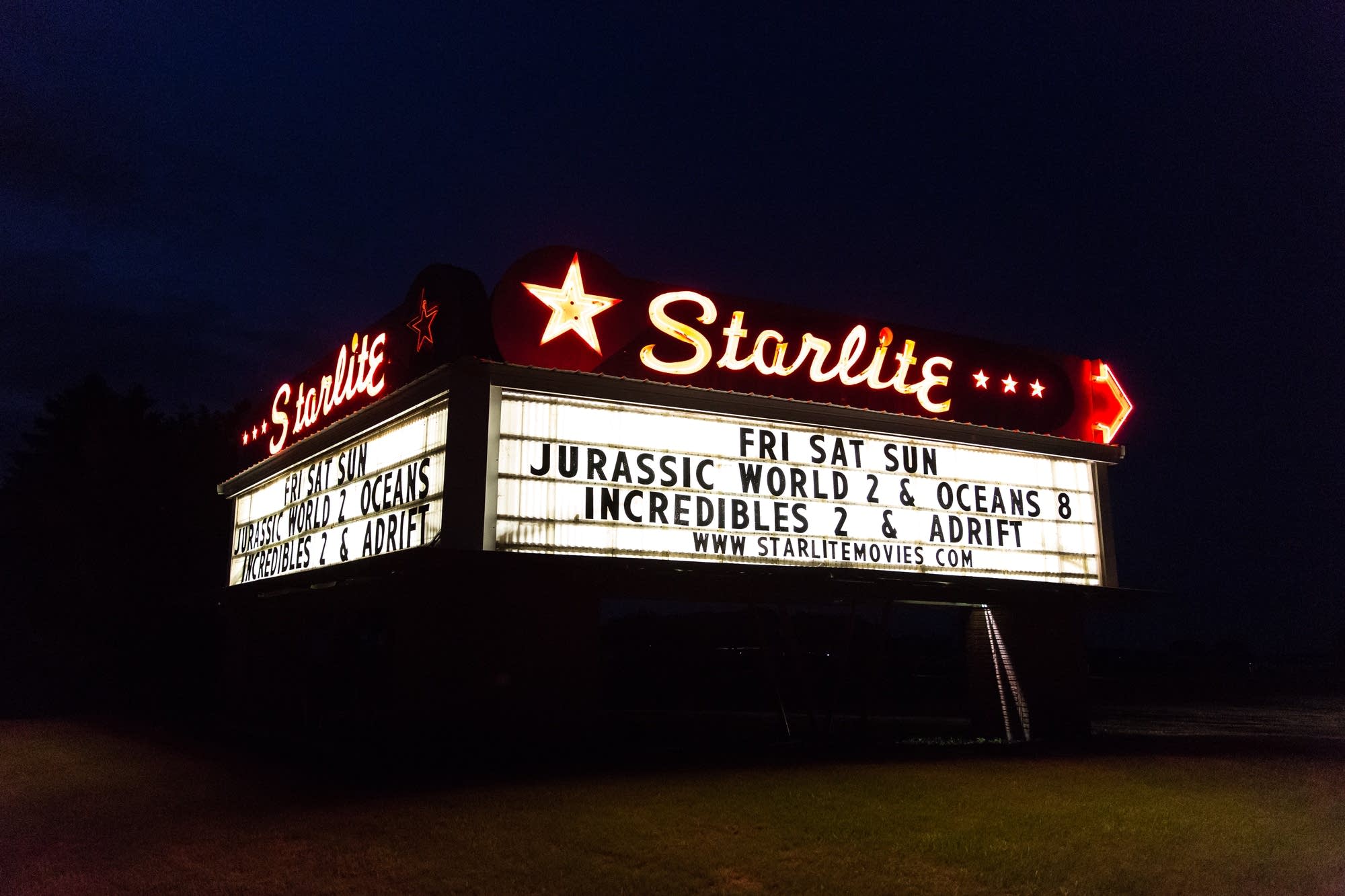 The Starlite Drive-In Theater's neon marquee sits alongside Highway 22.