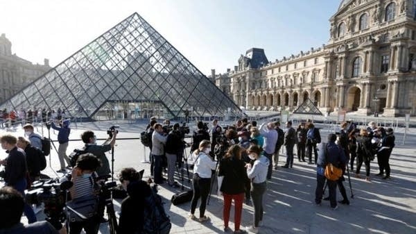 Lines form outside the Louvre as it reopens. But the museum says it needs foreign visitors. 