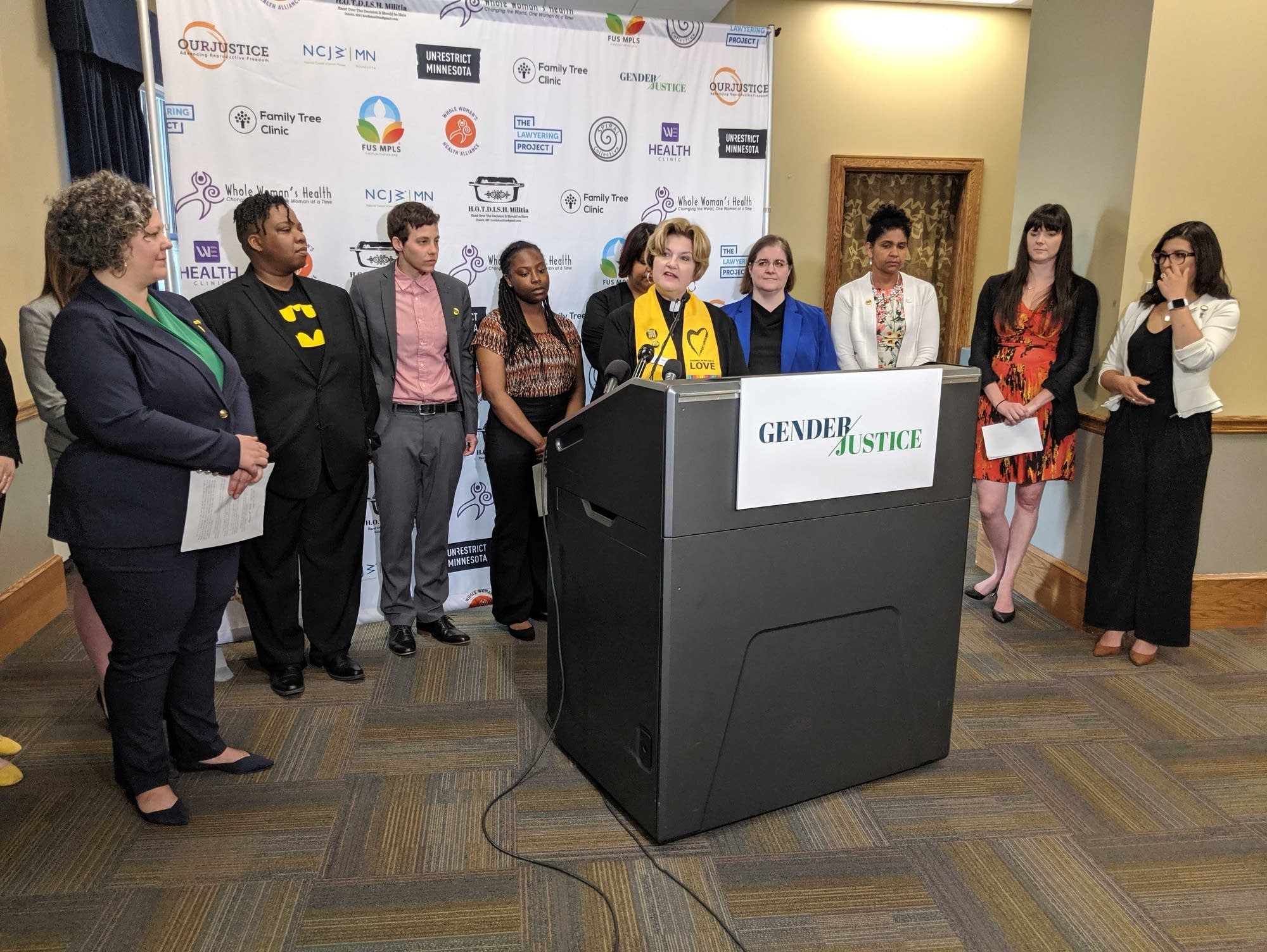 Kelli Clement, social justice ministe, speaks at a press conference
