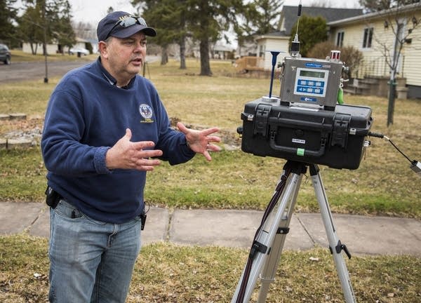 Jim Mitchell, onsite coordinator for the EPA, explains air monitoring.