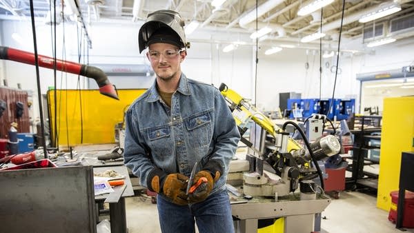 Lancaster works on a hydraulic table he is building for a local company.