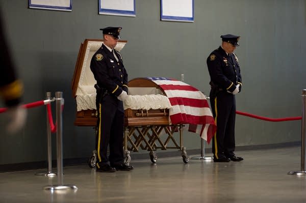 Officer Jason Moszer, attended by fellow officers.