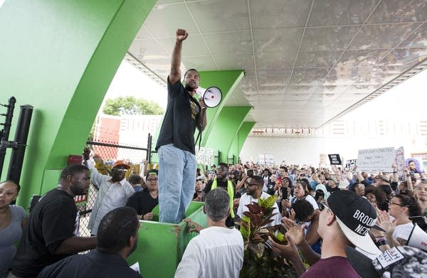 Rashad Turner lead protesters at the fair gates.