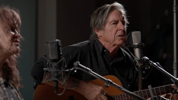Two musicians performing in a recording studio