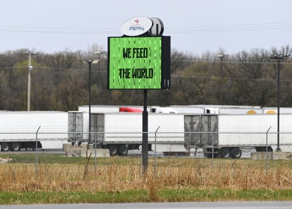 A sign near the road reads "We feed the world"