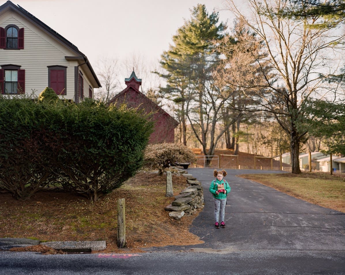 Children wait for their morning bus to school.