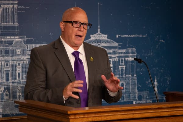 A man speaks at a press conference.
