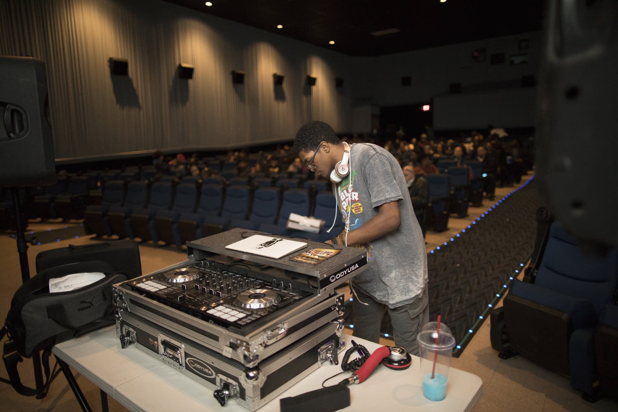 Sincere Arnett sets up DJ equipment for the Black Panther premiere party.