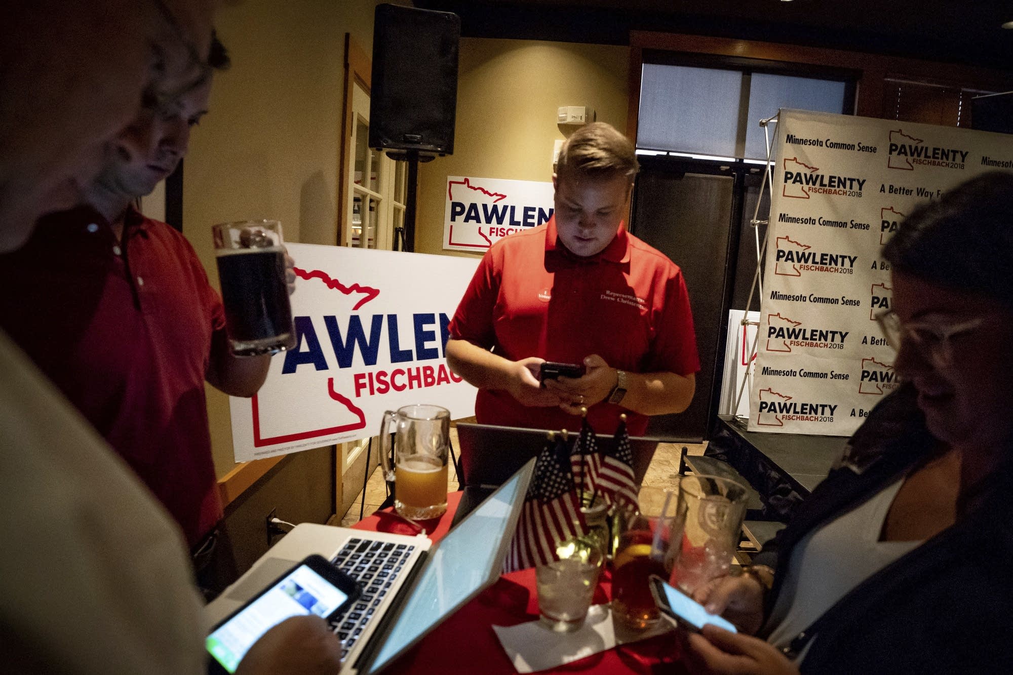 Tim Pawlenty supporters check results at his election night gathering.