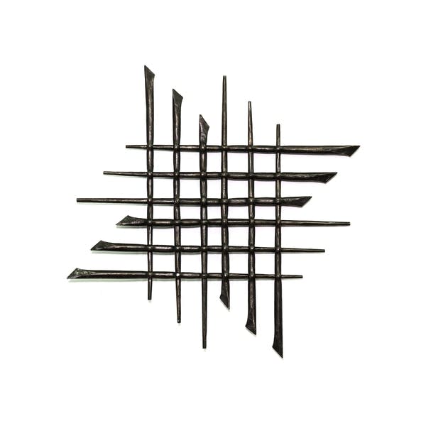 Sharp metal pieces crisscross over each other to create an art piece.