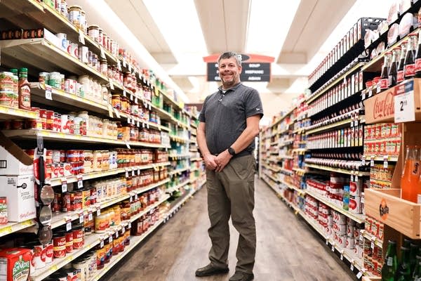 Man posing for photo in grocery store aisle