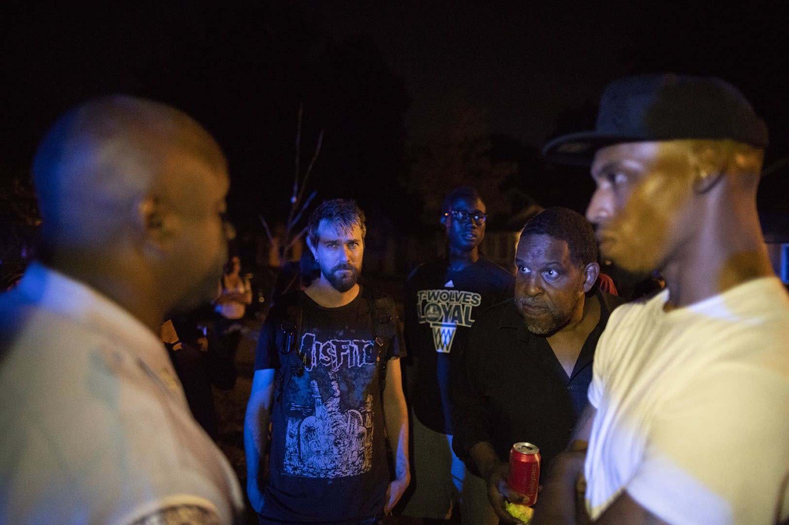 Mel Reeves, a community activist talks to a police officer.