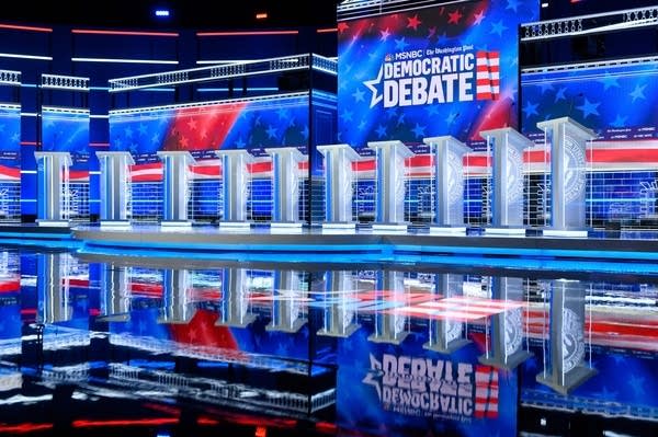 A stage lined with podiums for a debate.