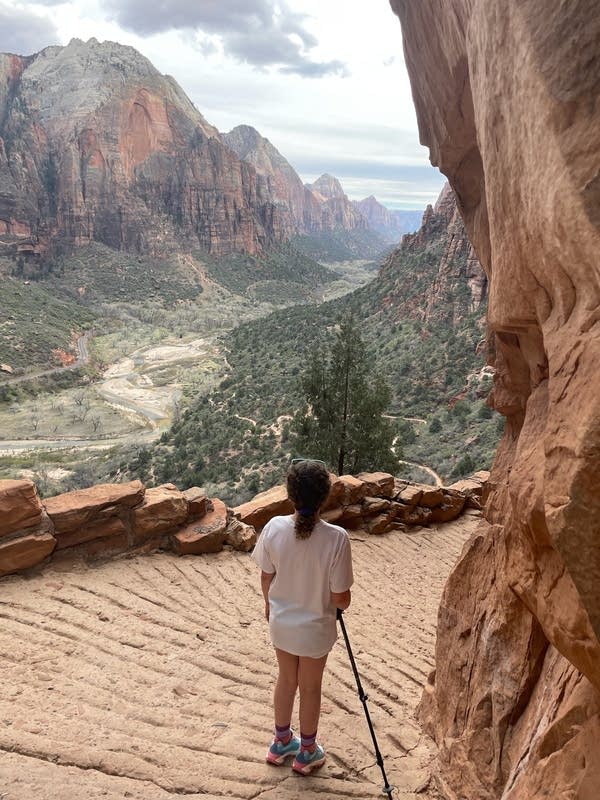 A young girl hiking looks toward the walk 