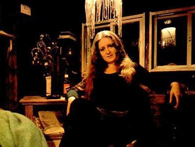 A picture of Bonnie Raitt sitting and looking at the camera