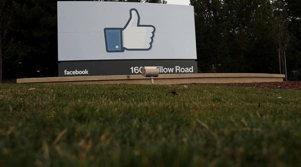 A sign with the 'like' symbol stands in front of the Facebook headquarters on February 1, 2012 in Menlo Park, California.