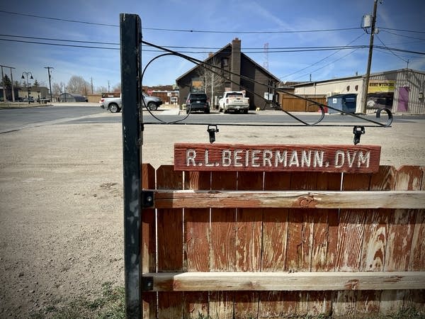 A wooden sign that says "R.L. Beiermann DVM" and is infront of a gravel parking lot.