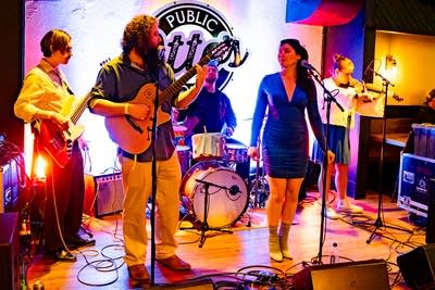 A band performing onstage in a music venue