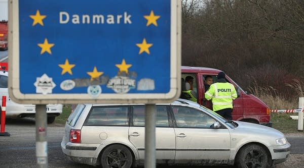  Danish police conducting spot checks on incoming traffic check the documents of the passengers of a van arriving from Germany. Denmark has introduced stricter rules when it comes to migration, including seizing valuables. 