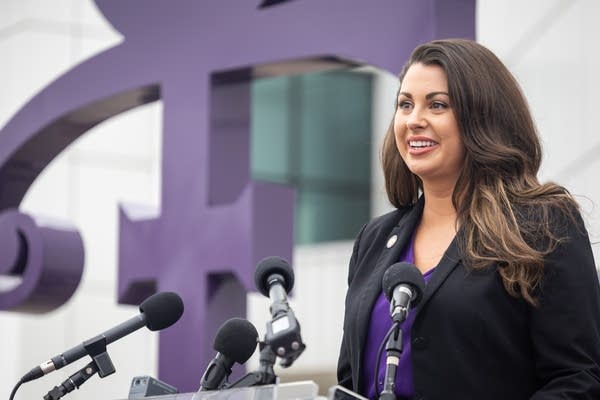 A woman speaks at a podium
