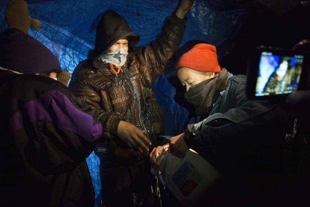 Niko Georgiades, far right, livestreams a protest.