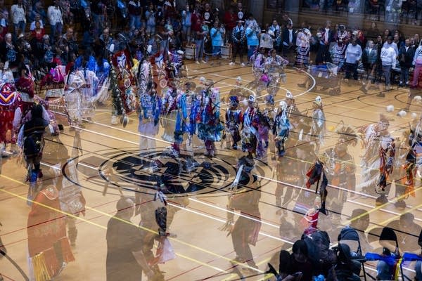Double exposure shot of a gymnasium floor with different groups of performers.