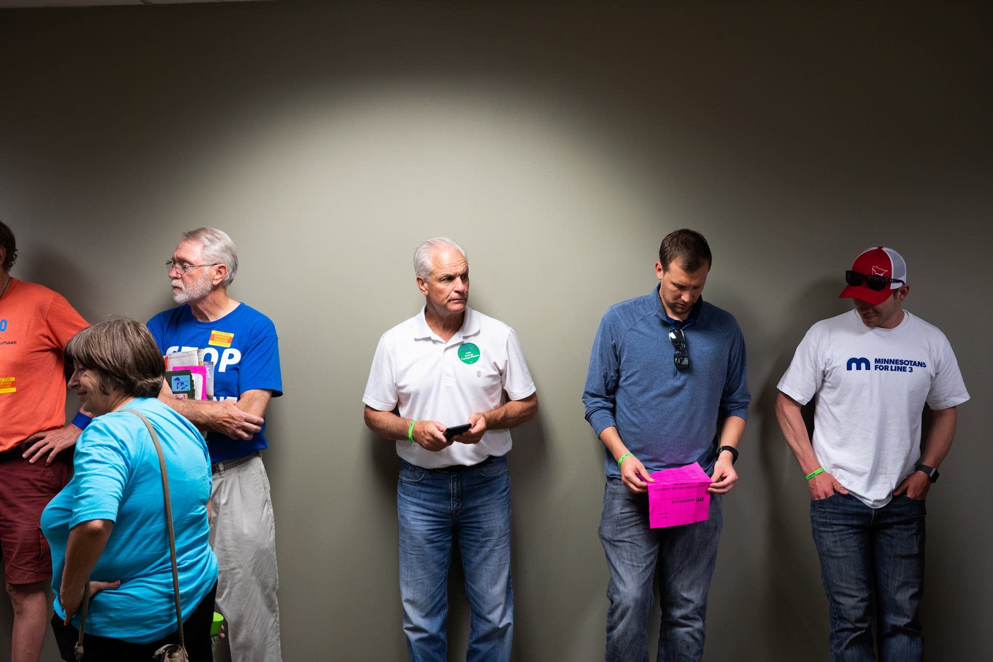 Pipeline supporters and opponents wait in the hall.