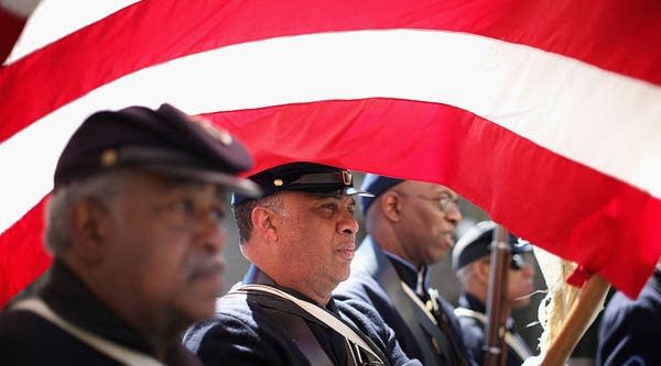 African American Civil War re-enactors march down Pennsylvania Avenue during the Emancipation Day parade April 16, 2014 in Washington, DC.